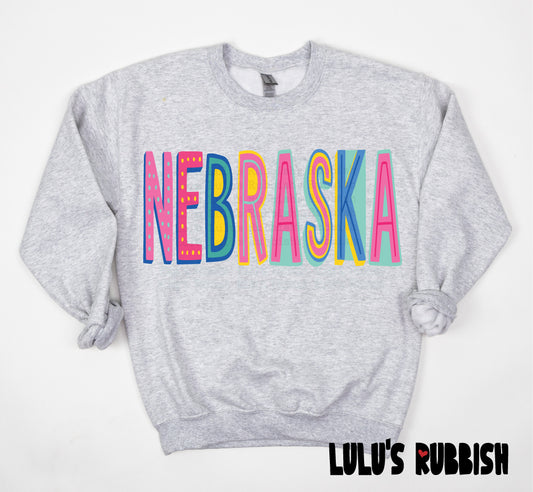 Nebraska PNG, Colorful Retro Nebraska Shirt Design, Nebraska State Pride Graphic, Groovy Colorful Typography PNG